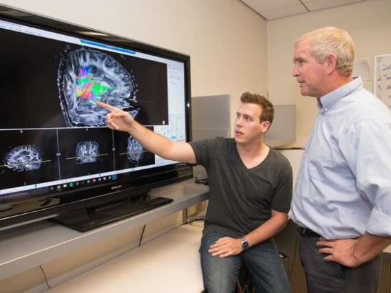 Dr. Trouard with his former student Adam Berstien looking at MRI images