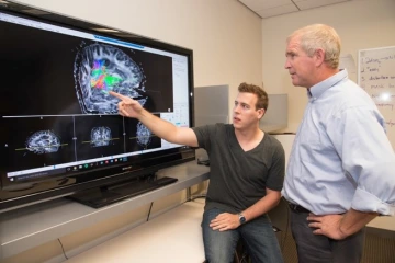 Dr. Trouard with his former student Adam Berstien looking at MRI images
